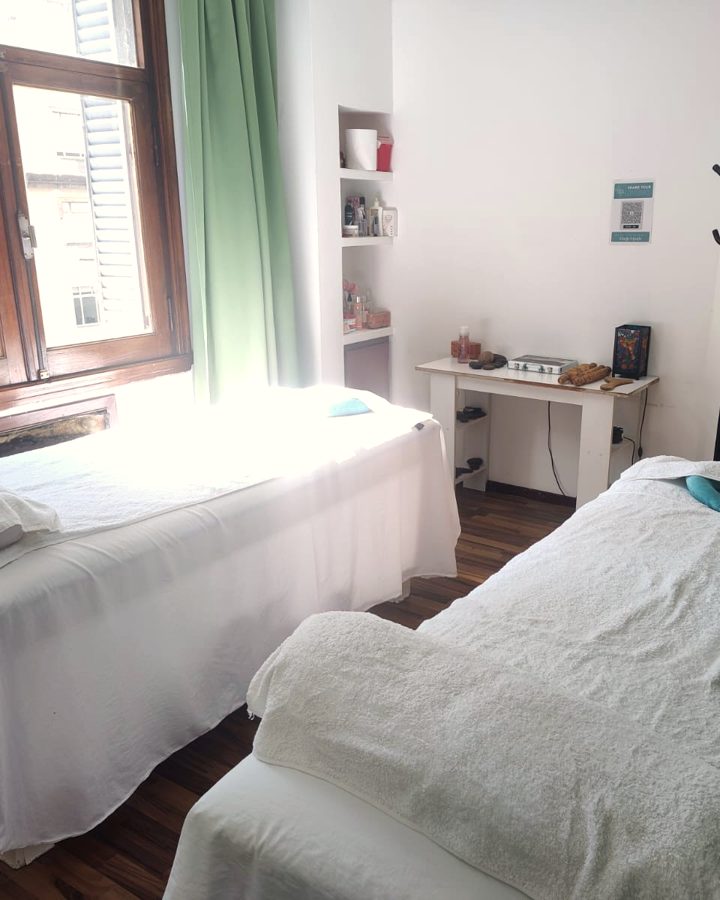 Sala doble con dos camillas y una gran ventana a la calle